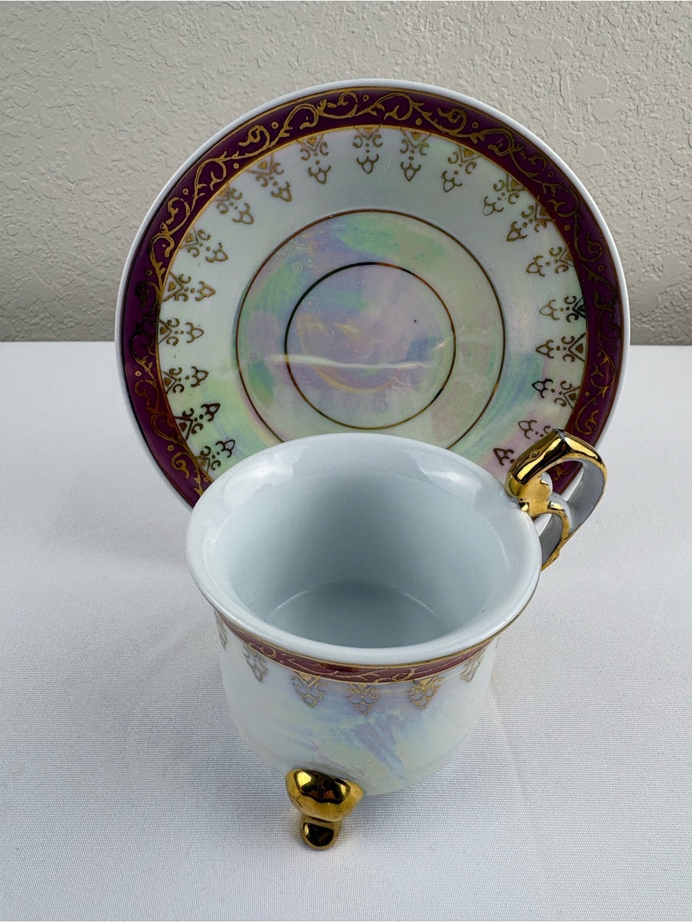 Vintage Porcelain Three-Legged Teacup and Saucer.